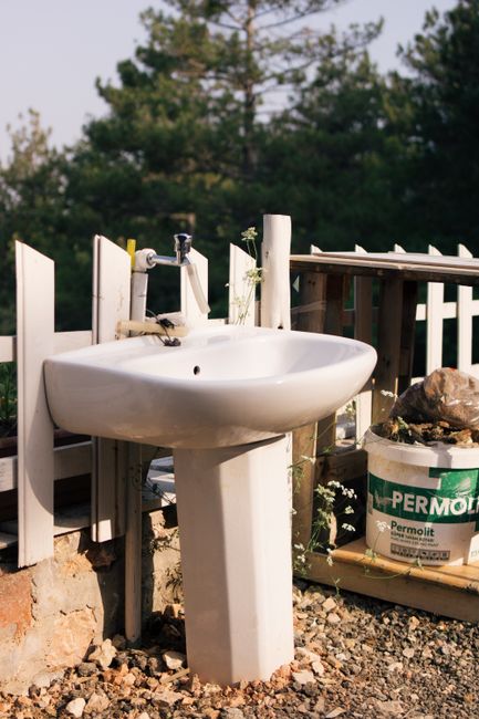 An off-grid home using a branched drain greywater system to irrigate a lush garden.